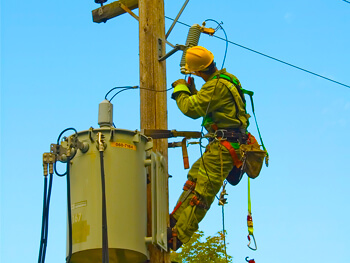 Electrician working on a high-voltage power line